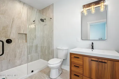 a kitchen with granite countertop white cabinets and stainless steel appliances
