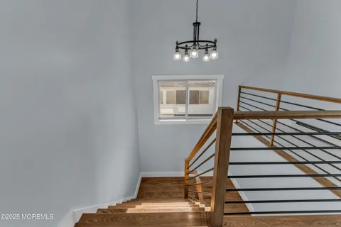 an empty room with windows and ceiling fan