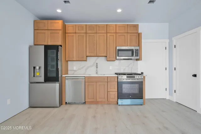 a view of a house with wooden deck