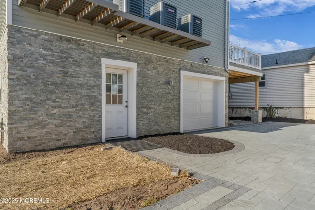 a view of a hallway with wooden staircase