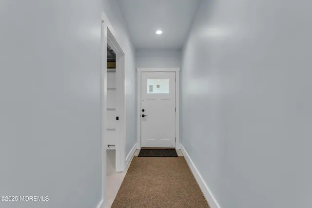 en empty room with windows and ceiling fan