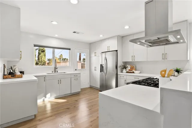 a kitchen with refrigerator and cabinets