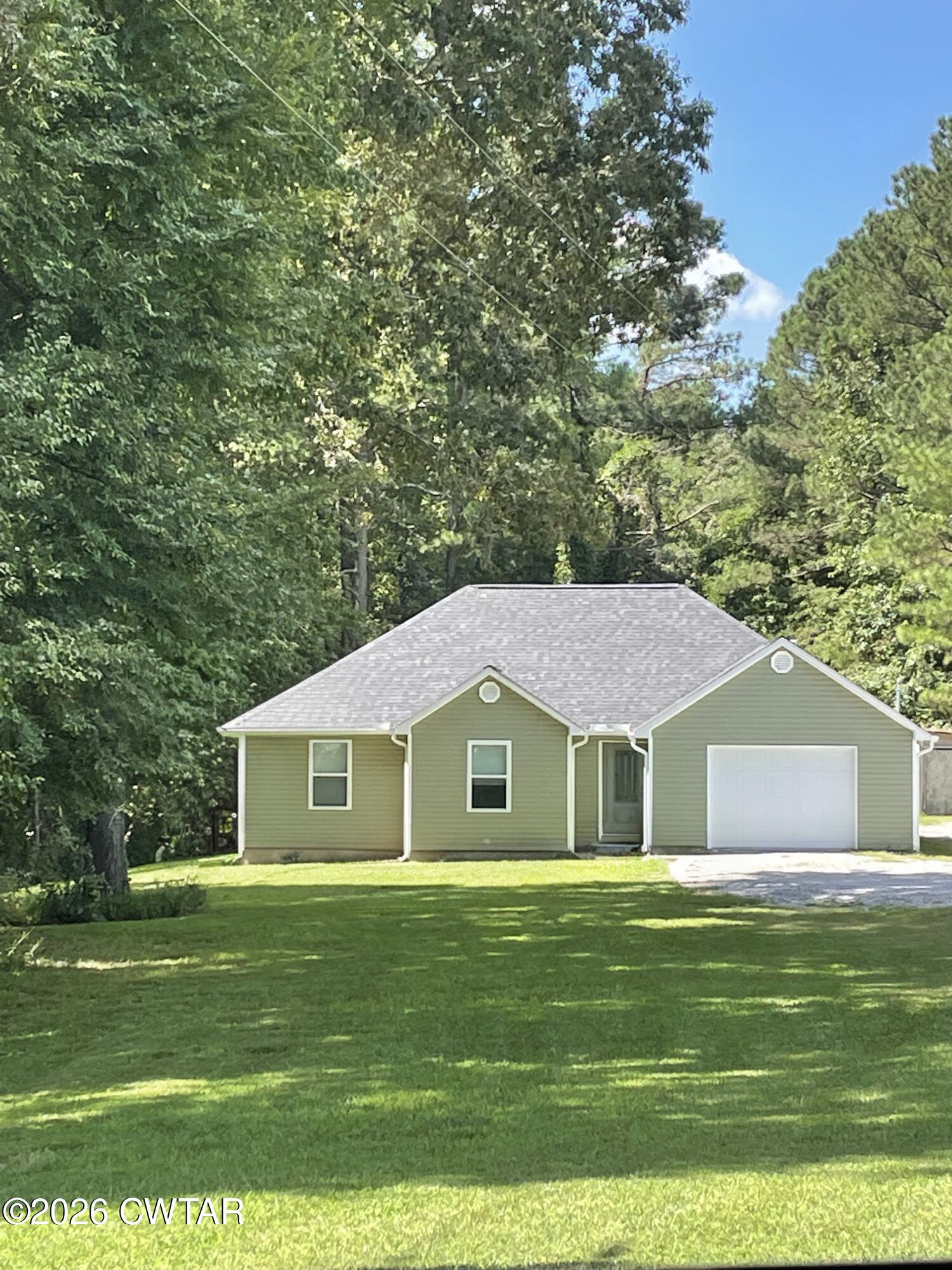 129 Gunner Lane Lexington, TN 38351 - Photo 1 of 19 a front view of a house with a garden