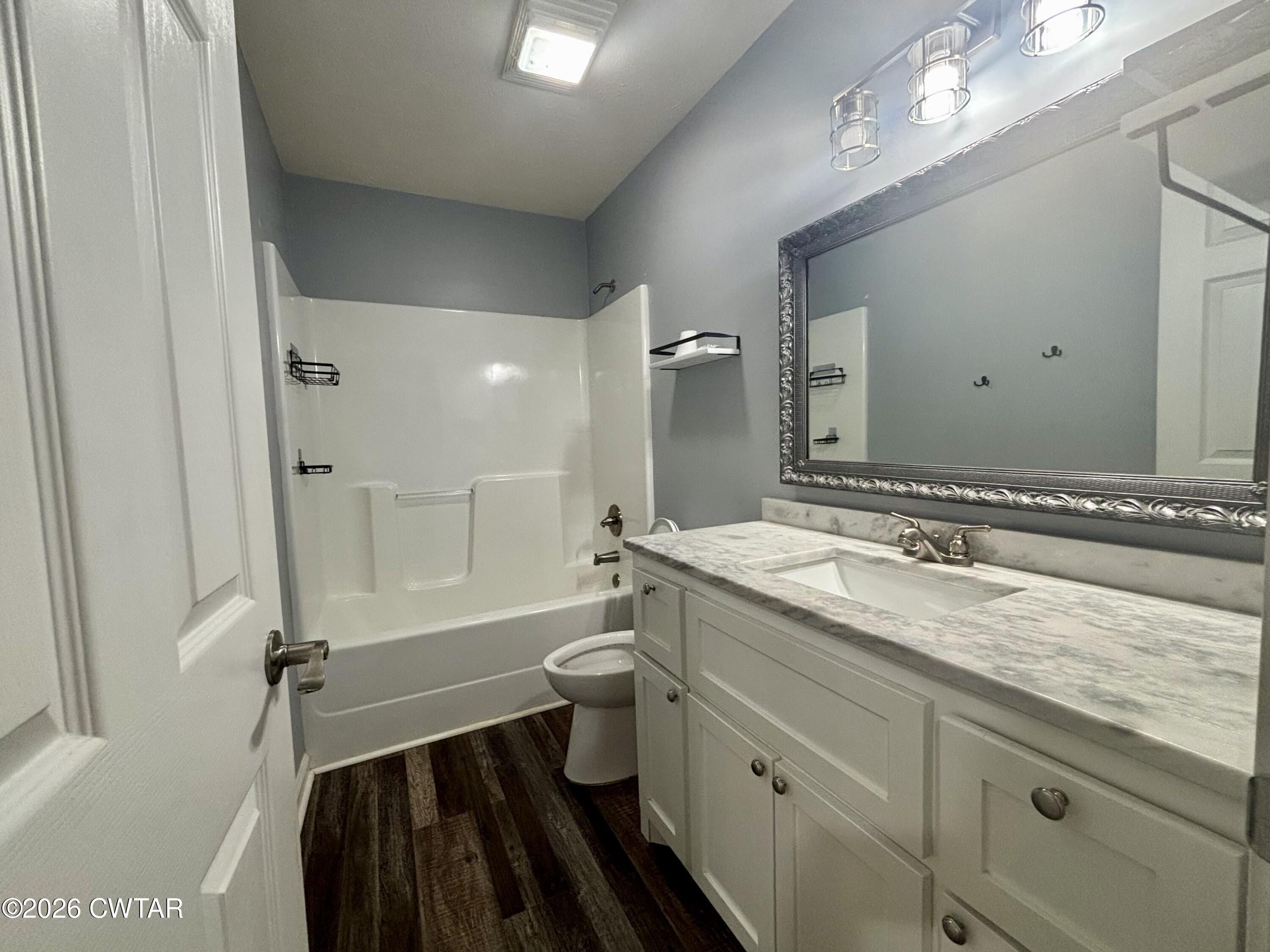 129 Gunner Lane Lexington, TN 38351 - Photo 14 of 19 a bathroom with a granite countertop sink mirror vanity and toilet