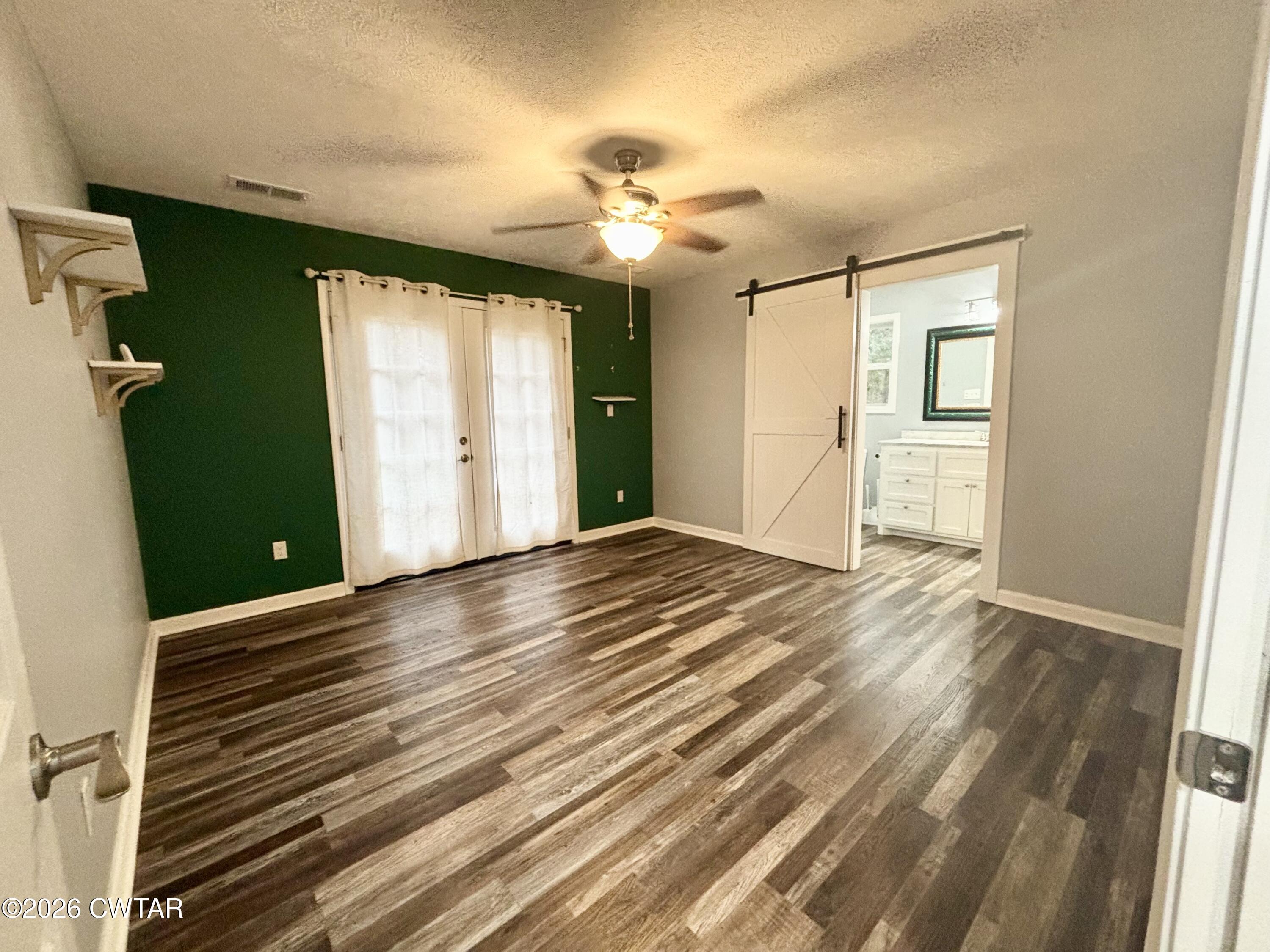 129 Gunner Lane Lexington, TN 38351 - Photo 7 of 19 a view of a livingroom with wooden floor and a ceiling fan