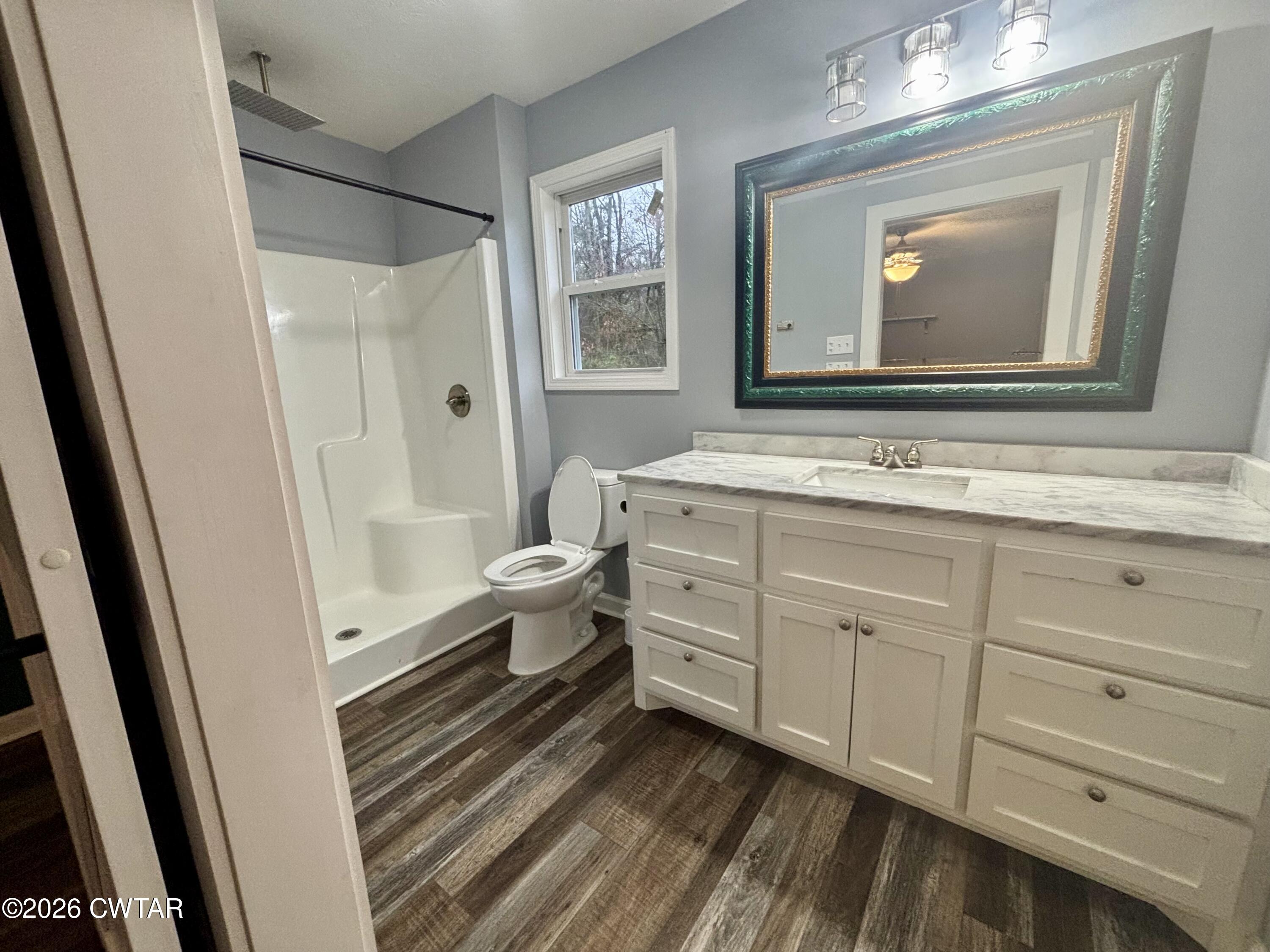 129 Gunner Lane Lexington, TN 38351 - Photo 8 of 19 a bathroom with a toilet sink and mirror