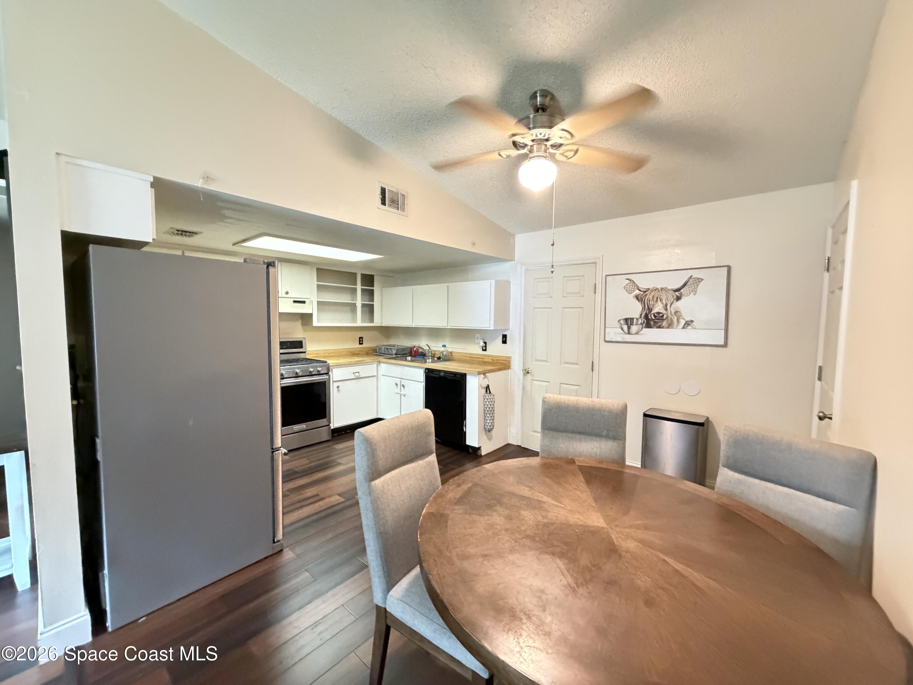1578 West Powder Horn Road Titusville, FL 32796 - Photo 6 of 22 a living room with furniture and kitchen view
