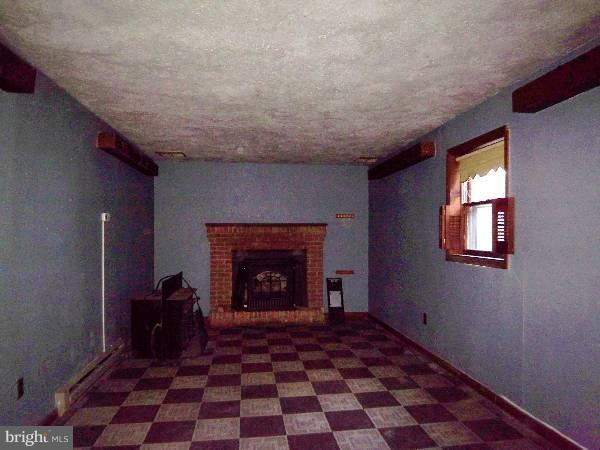 143 Holiday Road Cross Junction, VA 22625 - Photo 15 of 22 a view of a livingroom with a fireplace and window