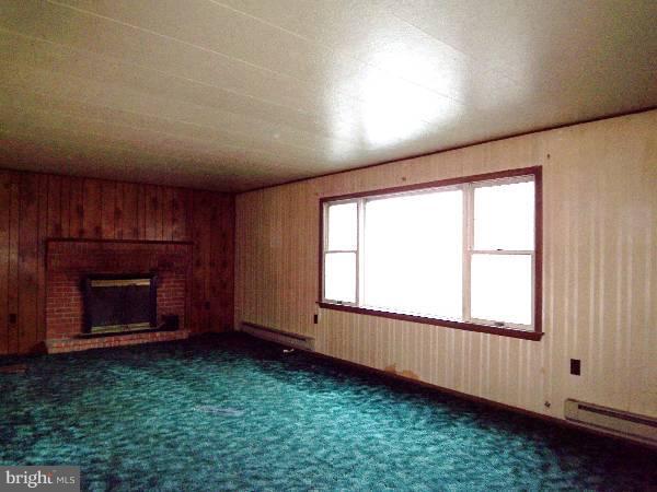 143 Holiday Road Cross Junction, VA 22625 - Photo 19 of 22 an empty room with windows and fireplace
