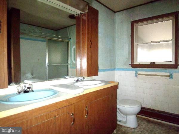 143 Holiday Road Cross Junction, VA 22625 - Photo 22 of 22 a bathroom with a granite countertop sink toilet and mirror