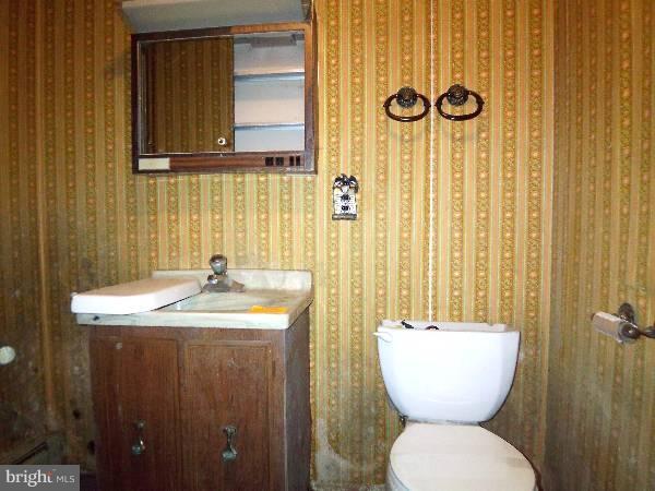 143 Holiday Road Cross Junction, VA 22625 - Photo 5 of 22 a bathroom with a toilet sink and mirror