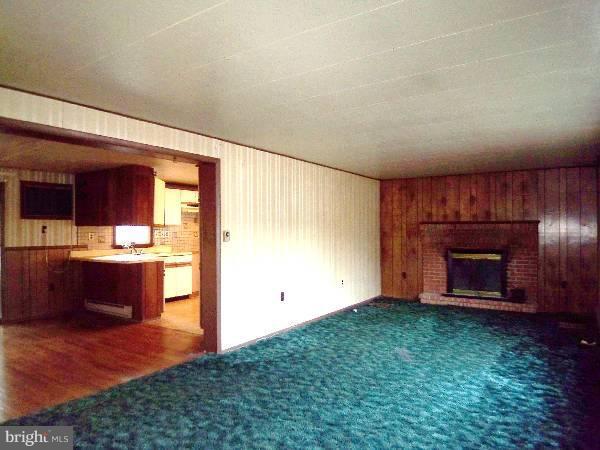 143 Holiday Road Cross Junction, VA 22625 - Photo 9 of 22 an empty room with a fireplace and entryway