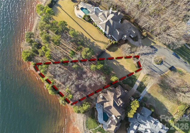 a view of a yard with wooden fence