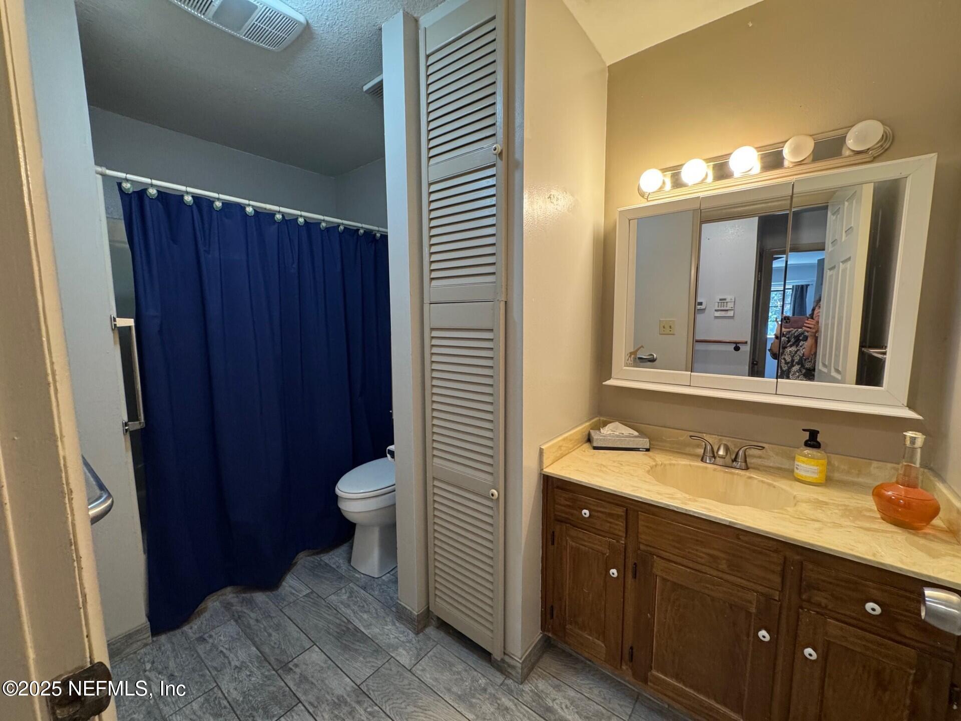 229 Davis Lake Road Palatka, FL 32177 - Photo 16 of 73 a bathroom with a granite countertop sink toilet and mirror