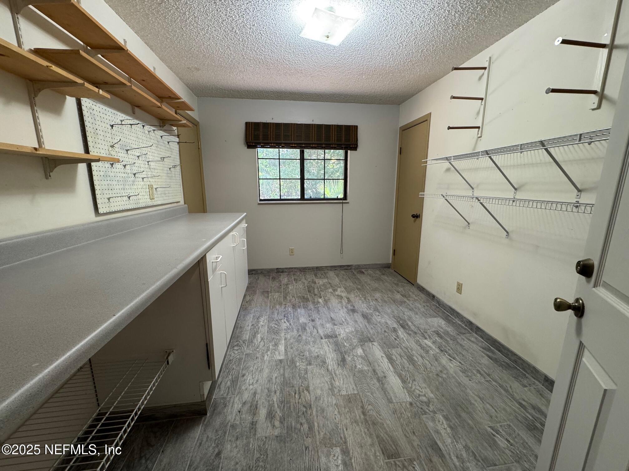 229 Davis Lake Road Palatka, FL 32177 - Photo 19 of 73 a view of room with window and refrigerator