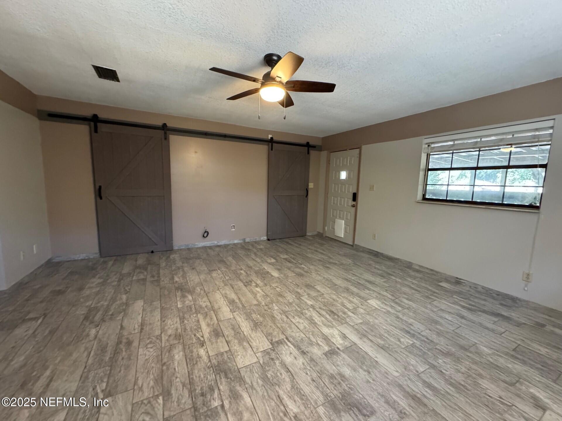 229 Davis Lake Road Palatka, FL 32177 - Photo 22 of 73 a view of empty room with wooden floor