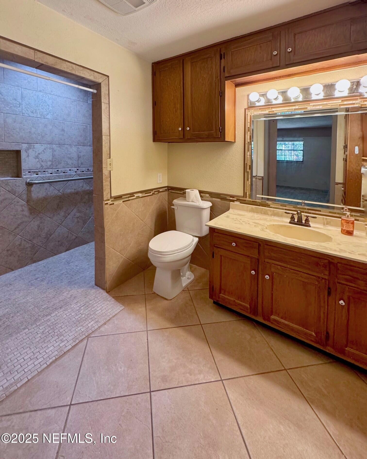 229 Davis Lake Road Palatka, FL 32177 - Photo 25 of 73 a spacious bathroom with a toilet sink and mirror