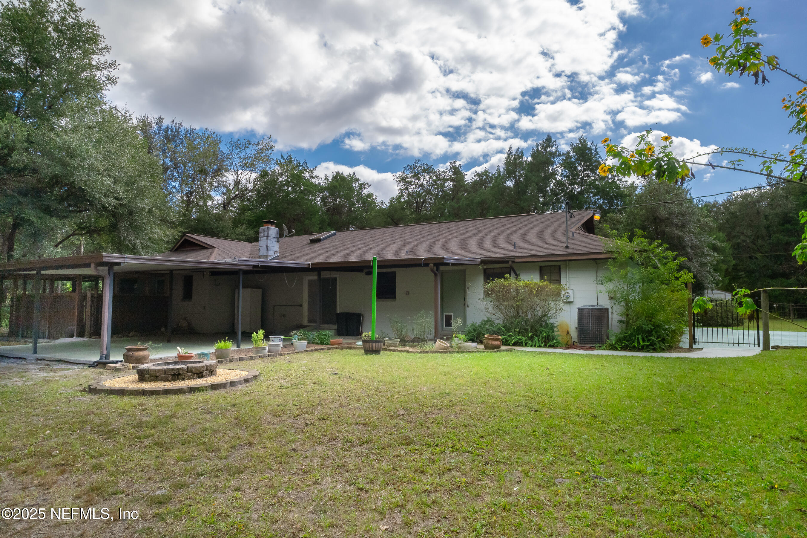 229 Davis Lake Road Palatka, FL 32177 - Photo 46 of 73 a view of a house with backyard and sitting area