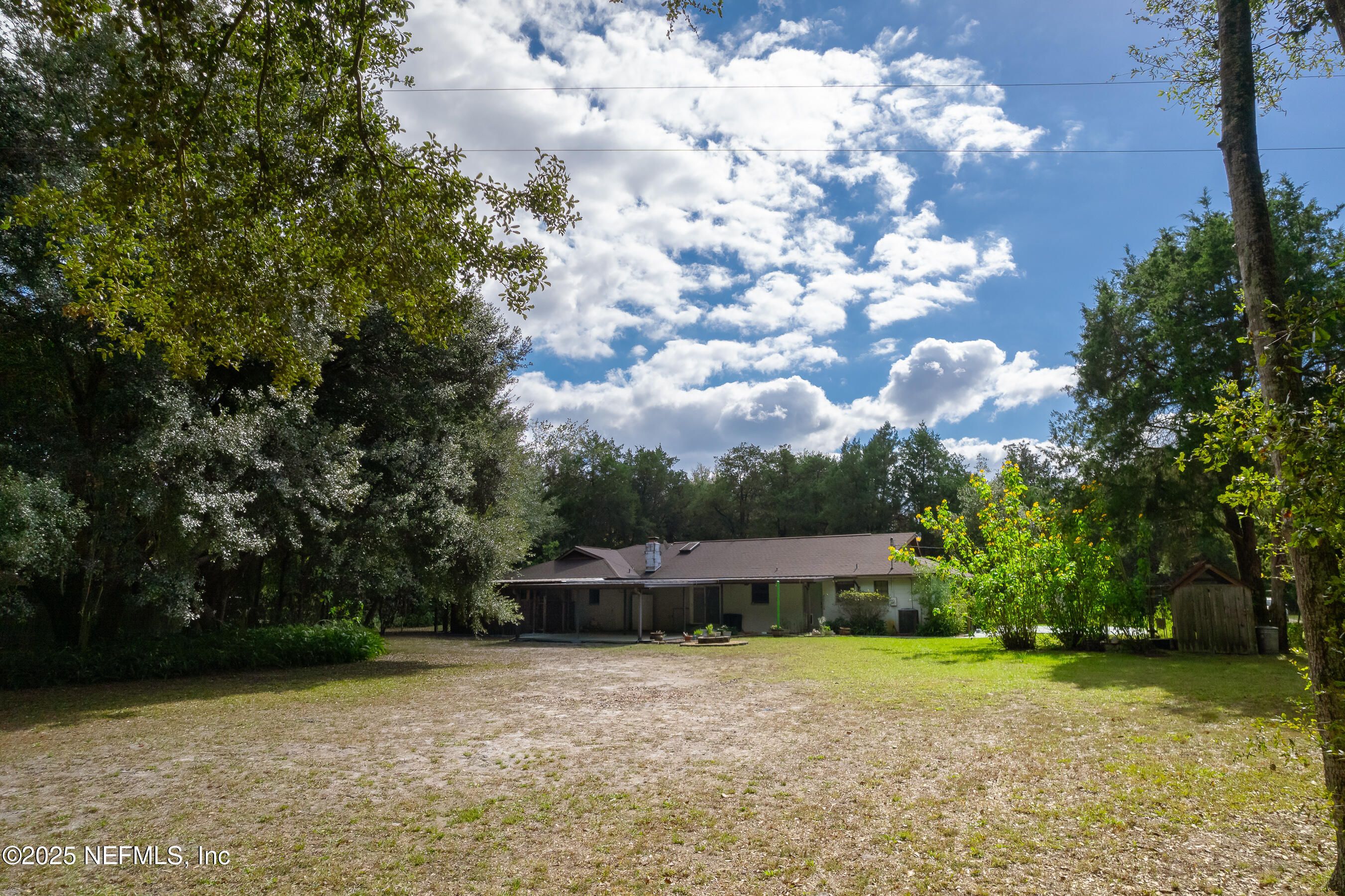 229 Davis Lake Road Palatka, FL 32177 - Photo 56 of 73 a view of a house with a yard and large trees