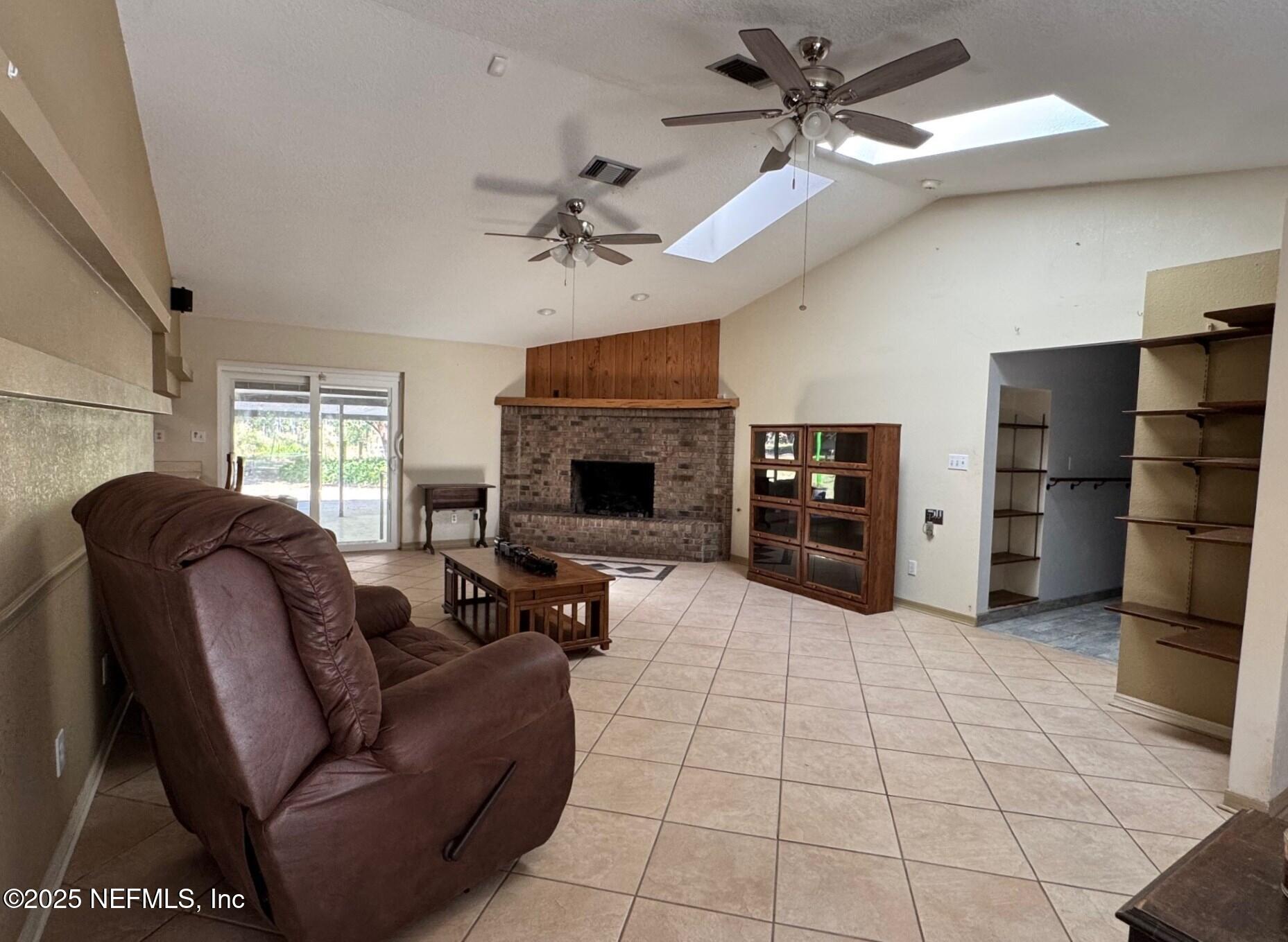 229 Davis Lake Road Palatka, FL 32177 - Photo 6 of 73 a living room with furniture and a fireplace