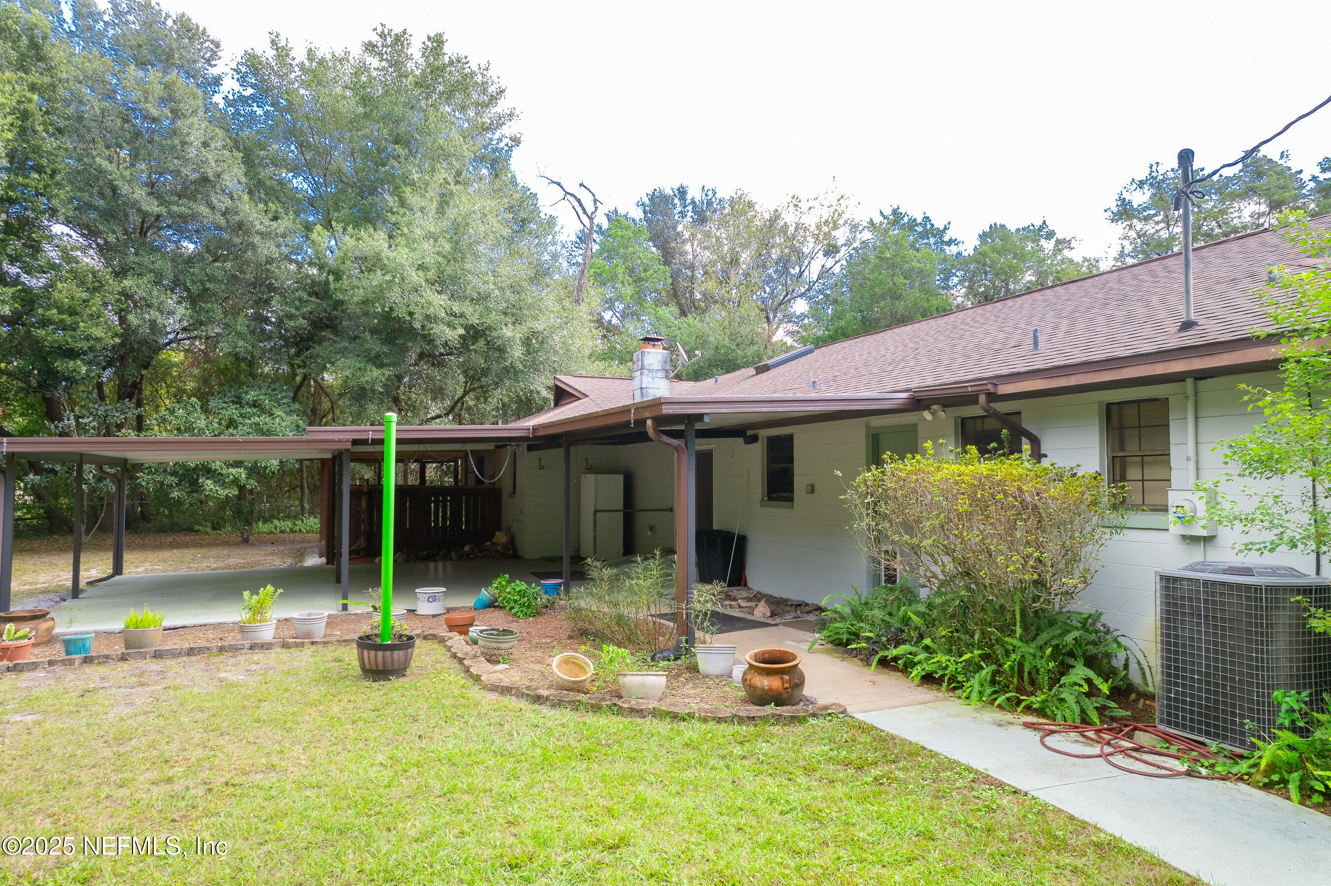 229 Davis Lake Road Palatka, FL 32177 - Photo 69 of 73 a view of a chair and table in backyard of the house