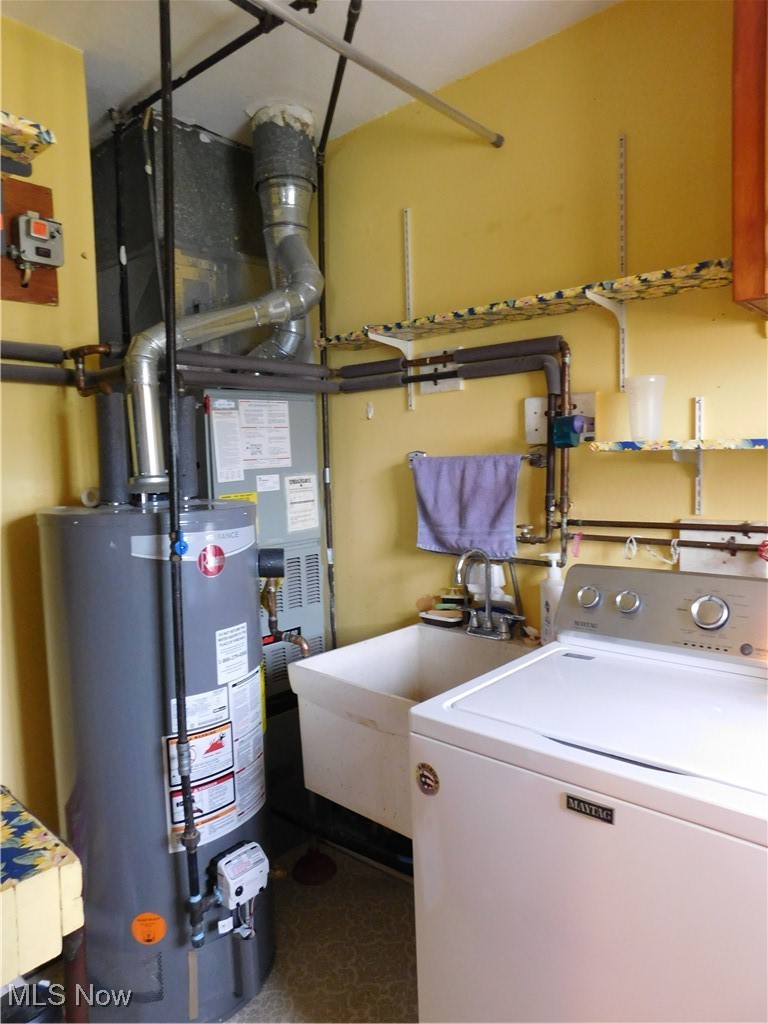 9255 Root Road North Ridgeville, OH 44039 - Photo 35 of 46 Utility room featuring water heater, washer / clothes dryer, laundry area, and a sink