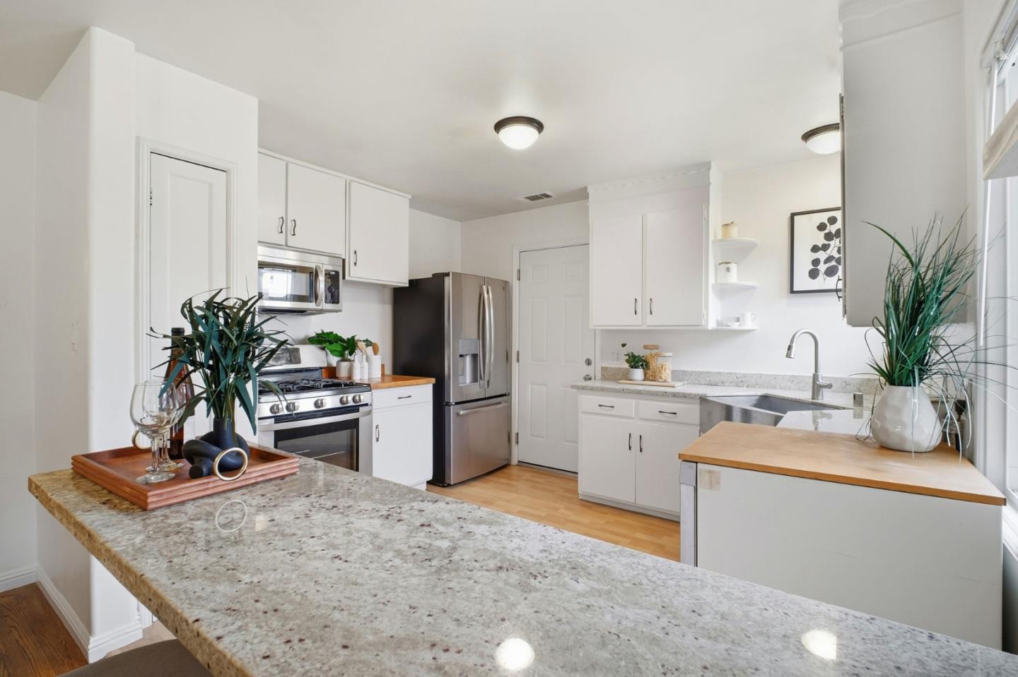 76 Georgia Way San Leandro, CA 94577 - Photo 12 of 32 a kitchen with a refrigerator a sink and cabinets