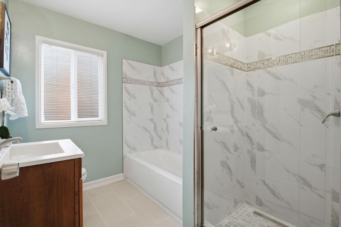 76 Georgia Way San Leandro, CA 94577 - Photo 24 of 32 a bathroom with a bathtub and a shower