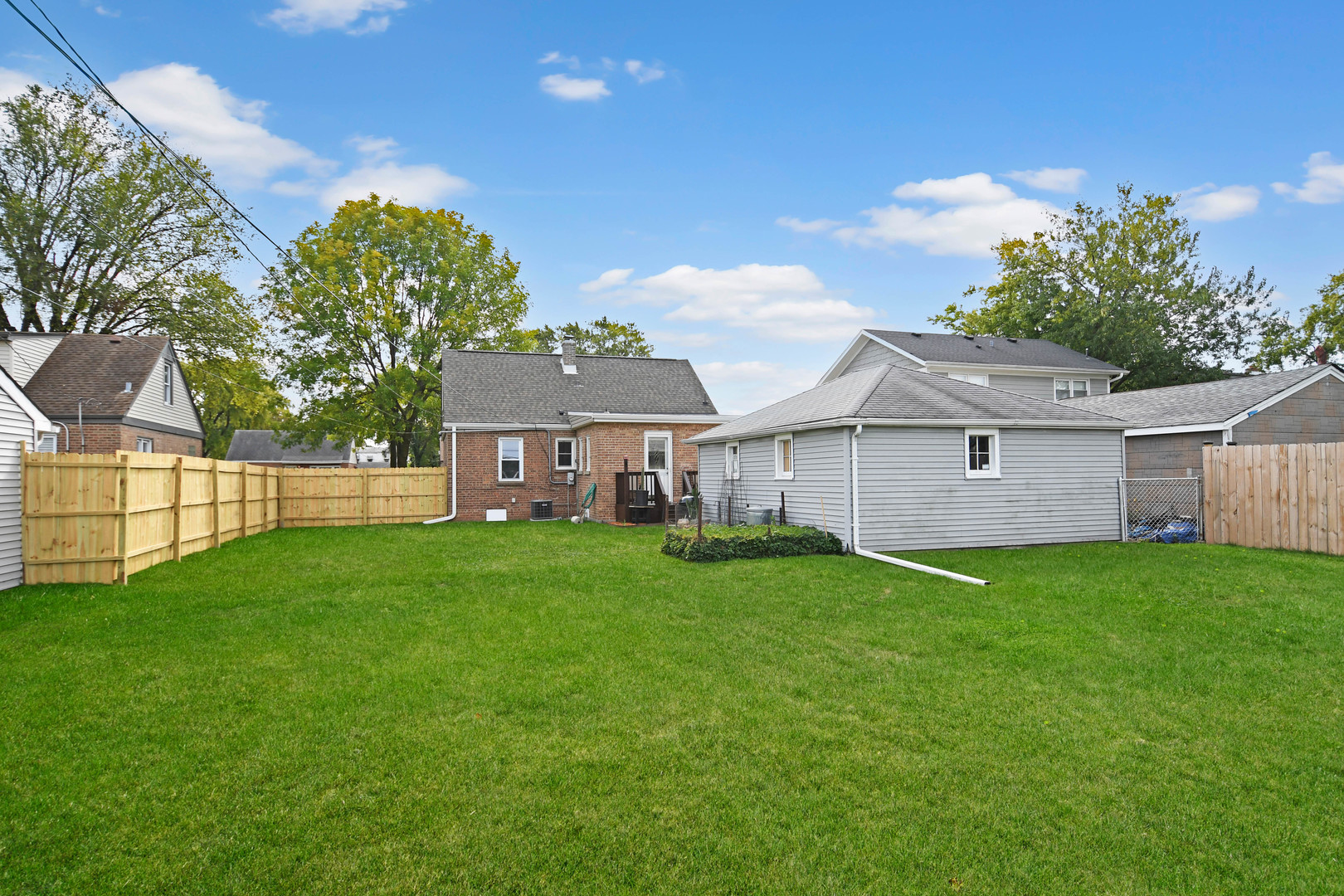 7828 Suburban Lane Bridgeview, IL 60455 - Photo 17 of 20 a view of a yard in front of a house with large trees