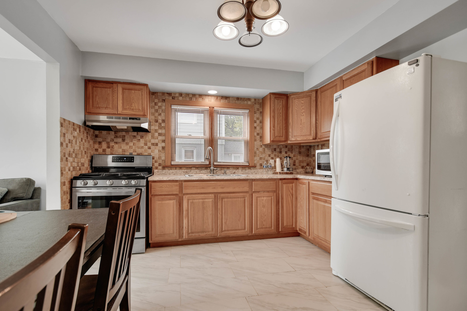 7828 Suburban Lane Bridgeview, IL 60455 - Photo 6 of 20 a kitchen with granite countertop a refrigerator stove top oven and sink