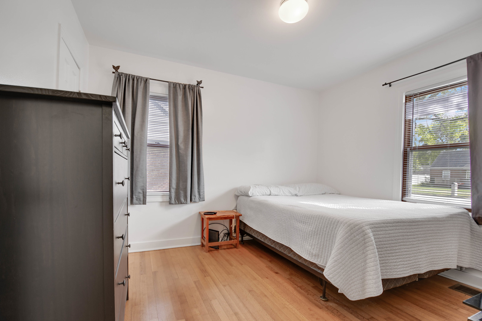 7828 Suburban Lane Bridgeview, IL 60455 - Photo 8 of 20 a bedroom with a bed and a window