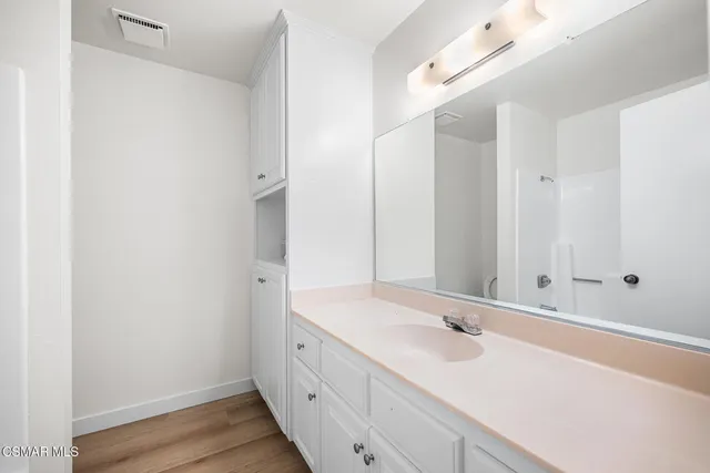 a bathroom with a sink and a large mirror