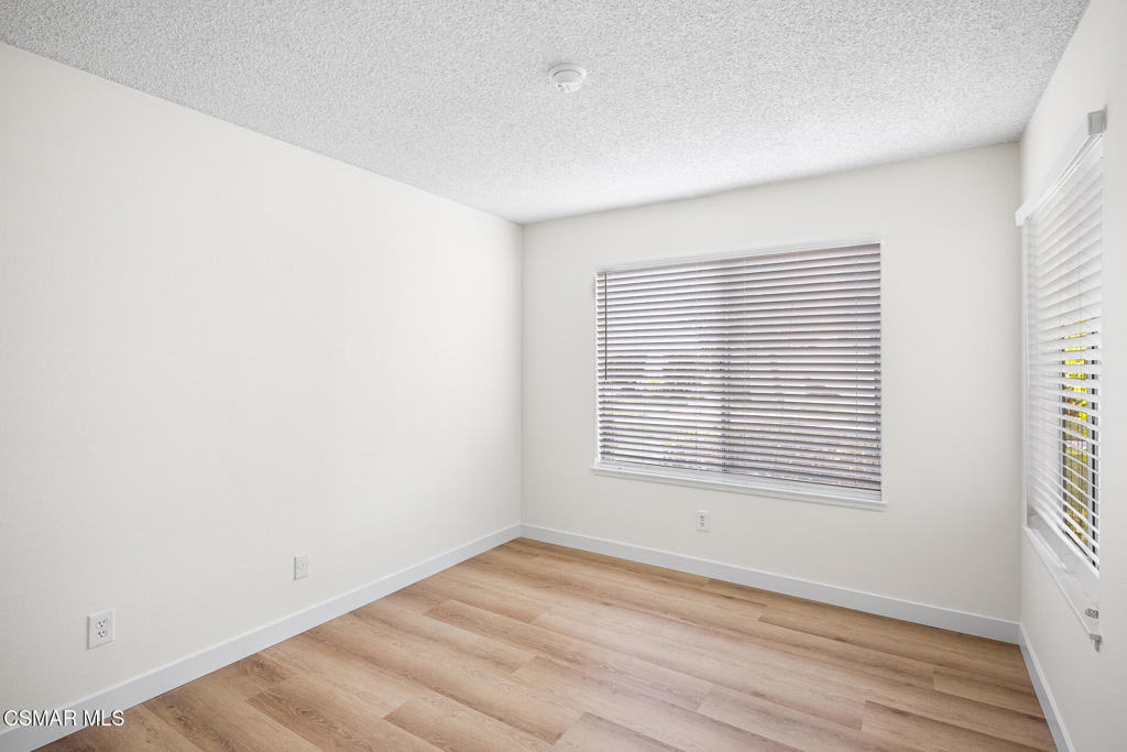 1748 Sinaloa Road, Unit 158 Simi Valley, CA 93065 - Photo 9 of 20 a view of an empty room with wooden floor and a window