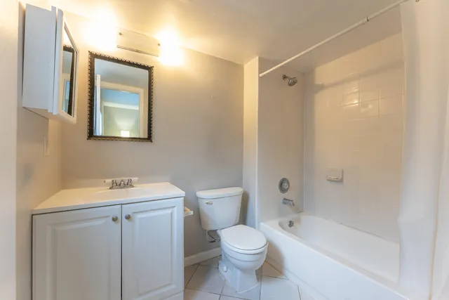 a view of a house with a patio and a yard