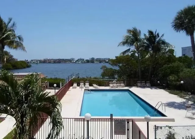 an aerial view of residential houses with outdoor space and lake view