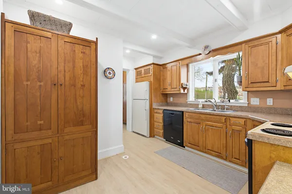 a kitchen with stainless steel appliances granite countertop a sink stove and cabinets