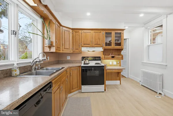 a kitchen with stainless steel appliances granite countertop a refrigerator stove and sink