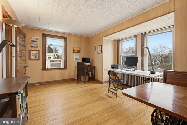 a workspace with furniture window and wooden floor