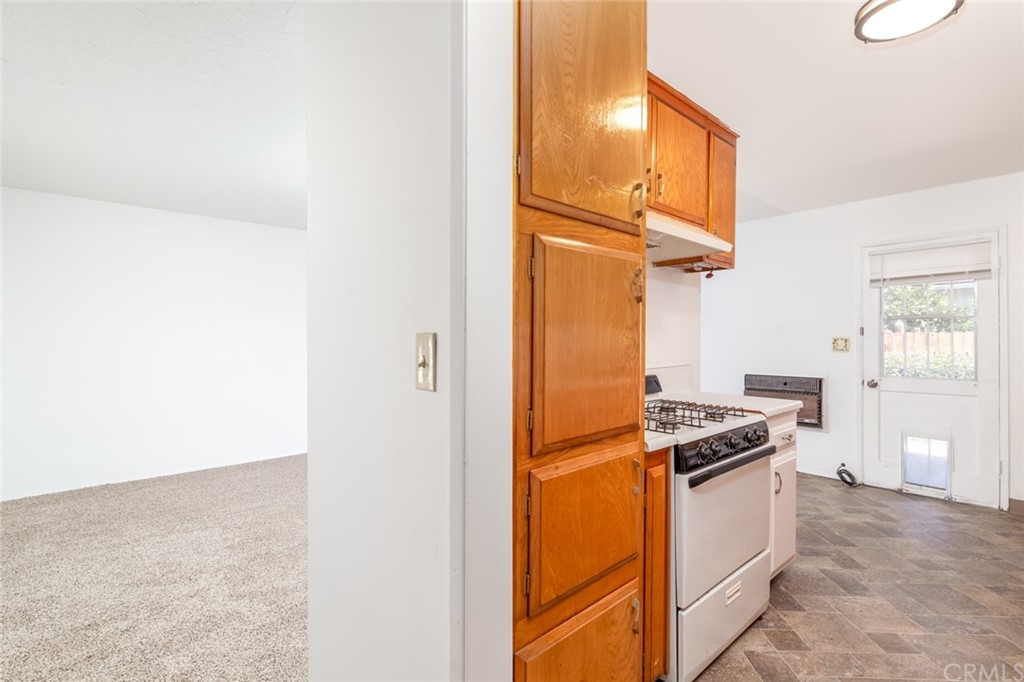 640 Snead Drive Hemet, CA 92543 - Photo 14 of 30 a kitchen with a refrigerator and white cabinets