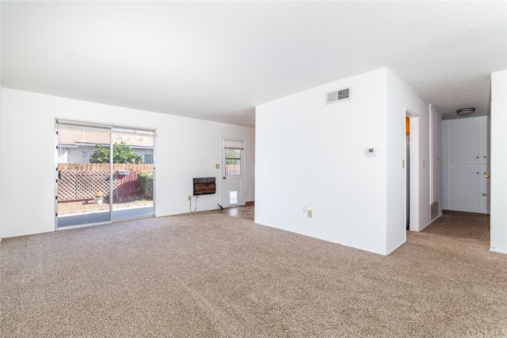 640 Snead Drive Hemet, CA 92543 - Photo 7 of 30 an empty room with furniture and a flat screen tv
