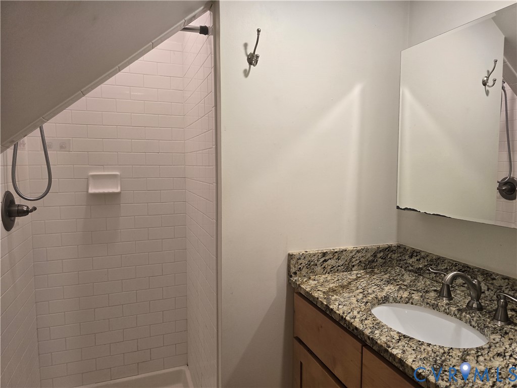 2106 Parkwood Avenue, Unit 1 Richmond, VA 23220 - Photo 13 of 20 a bathroom with a granite countertop sink and a mirror
