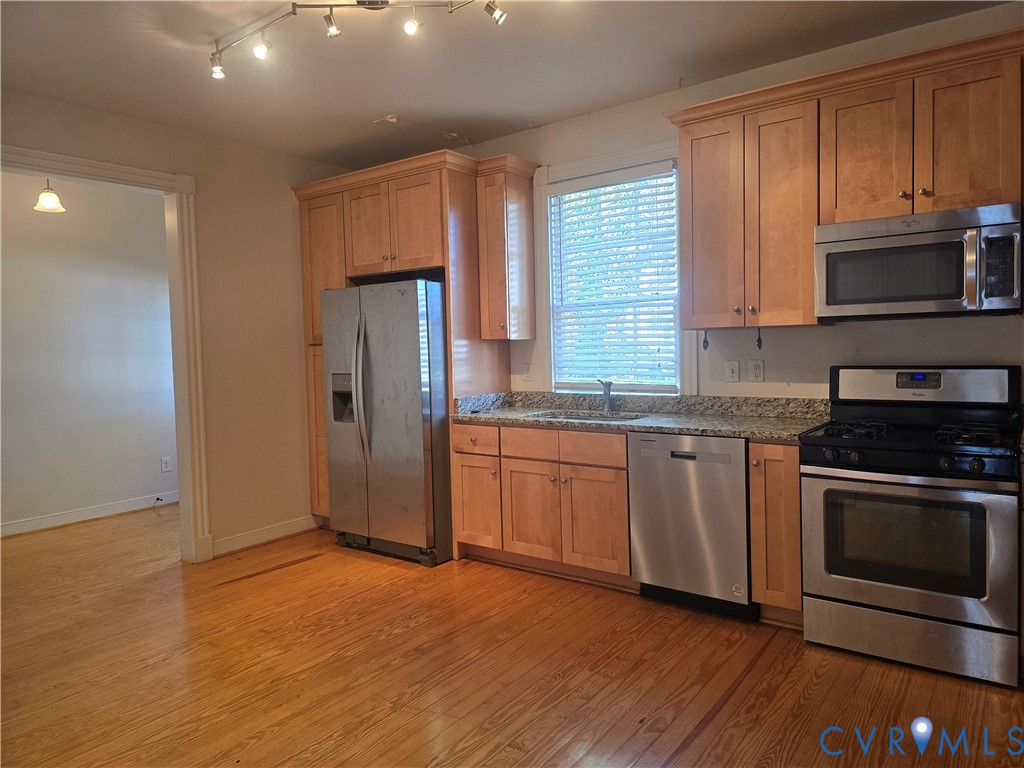 2106 Parkwood Avenue, Unit 1 Richmond, VA 23220 - Photo 2 of 20 a kitchen with granite countertop cabinets stainless steel appliances and a window