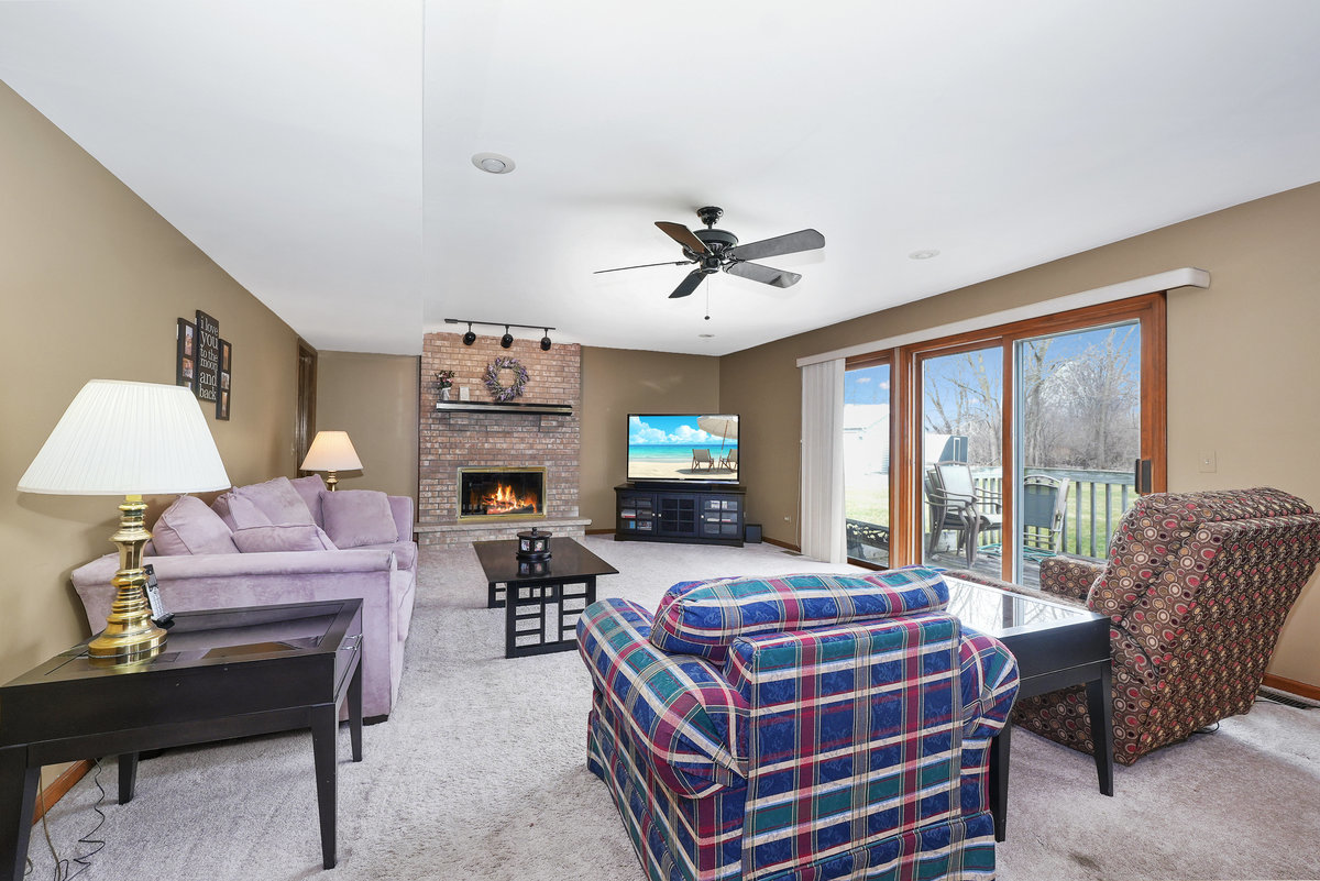 2 Valley View Drive Lemont, IL 60439 - Photo 11 of 36 a living room with furniture a fireplace and a flat screen tv