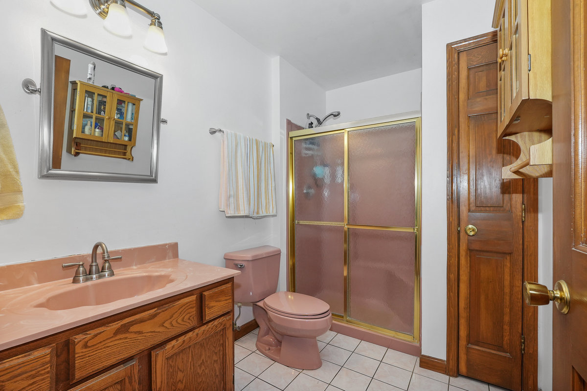 2 Valley View Drive Lemont, IL 60439 - Photo 14 of 36 a bathroom with a toilet sink vanity and shower