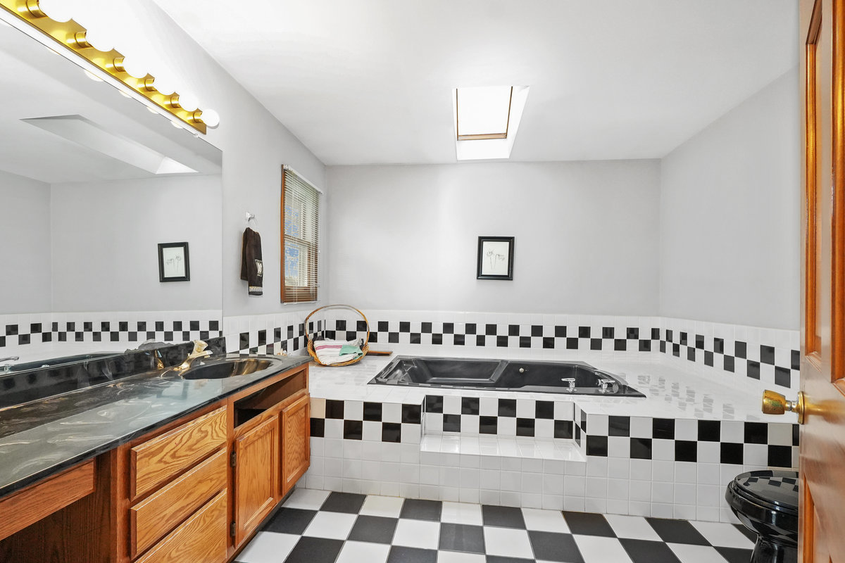 2 Valley View Drive Lemont, IL 60439 - Photo 19 of 36 a kitchen with granite countertop a sink and a black white cabinets