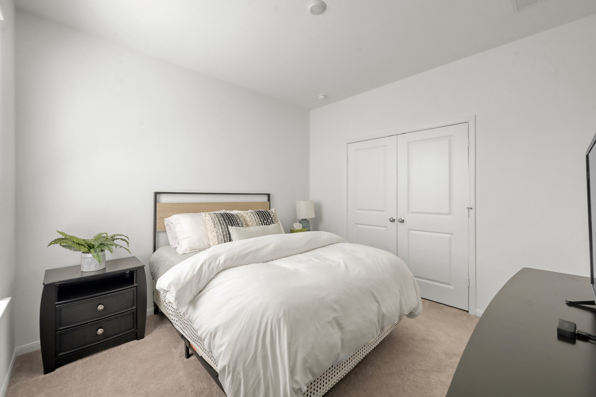 23562 Glenbuck Street Spring, TX 77373 - Photo 13 of 30 a bedroom with a bed and a potted plant