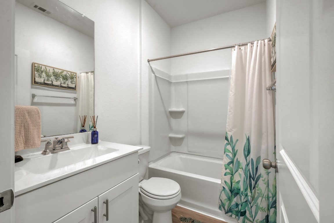 23562 Glenbuck Street Spring, TX 77373 - Photo 14 of 30 a bathroom with a sink a toilet a shower curtain and a large mirror