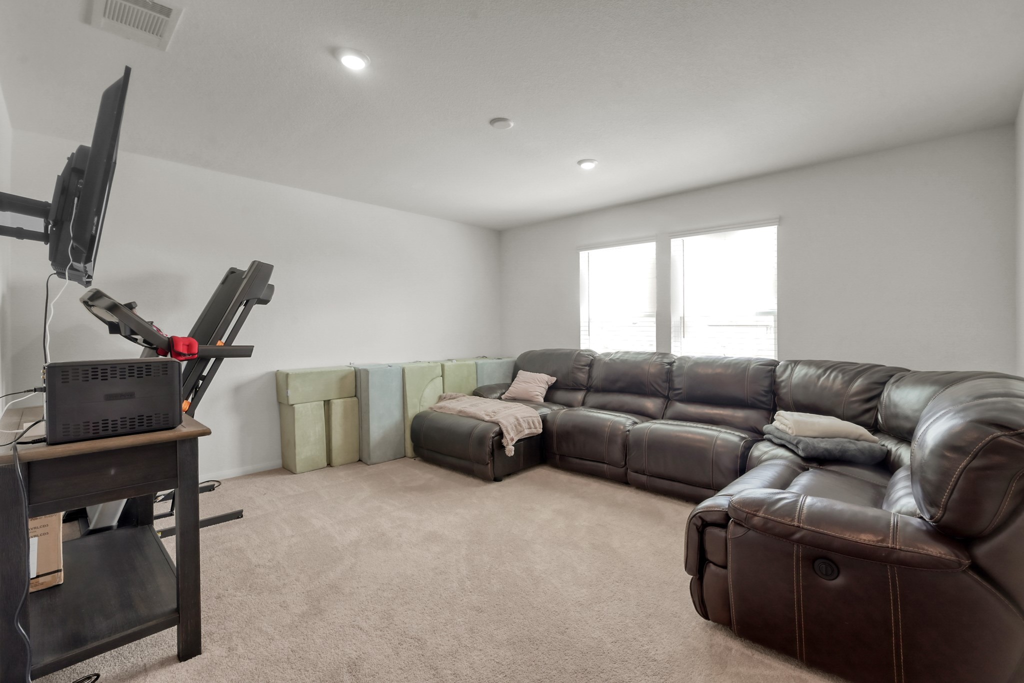 23562 Glenbuck Street Spring, TX 77373 - Photo 15 of 30 a living room with furniture a flat screen tv and a window