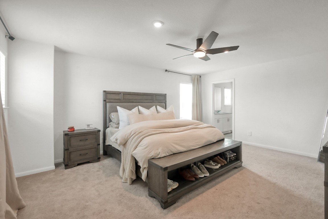 23562 Glenbuck Street Spring, TX 77373 - Photo 17 of 30 a bed sitting in a bedroom next to a window and a ceiling fan