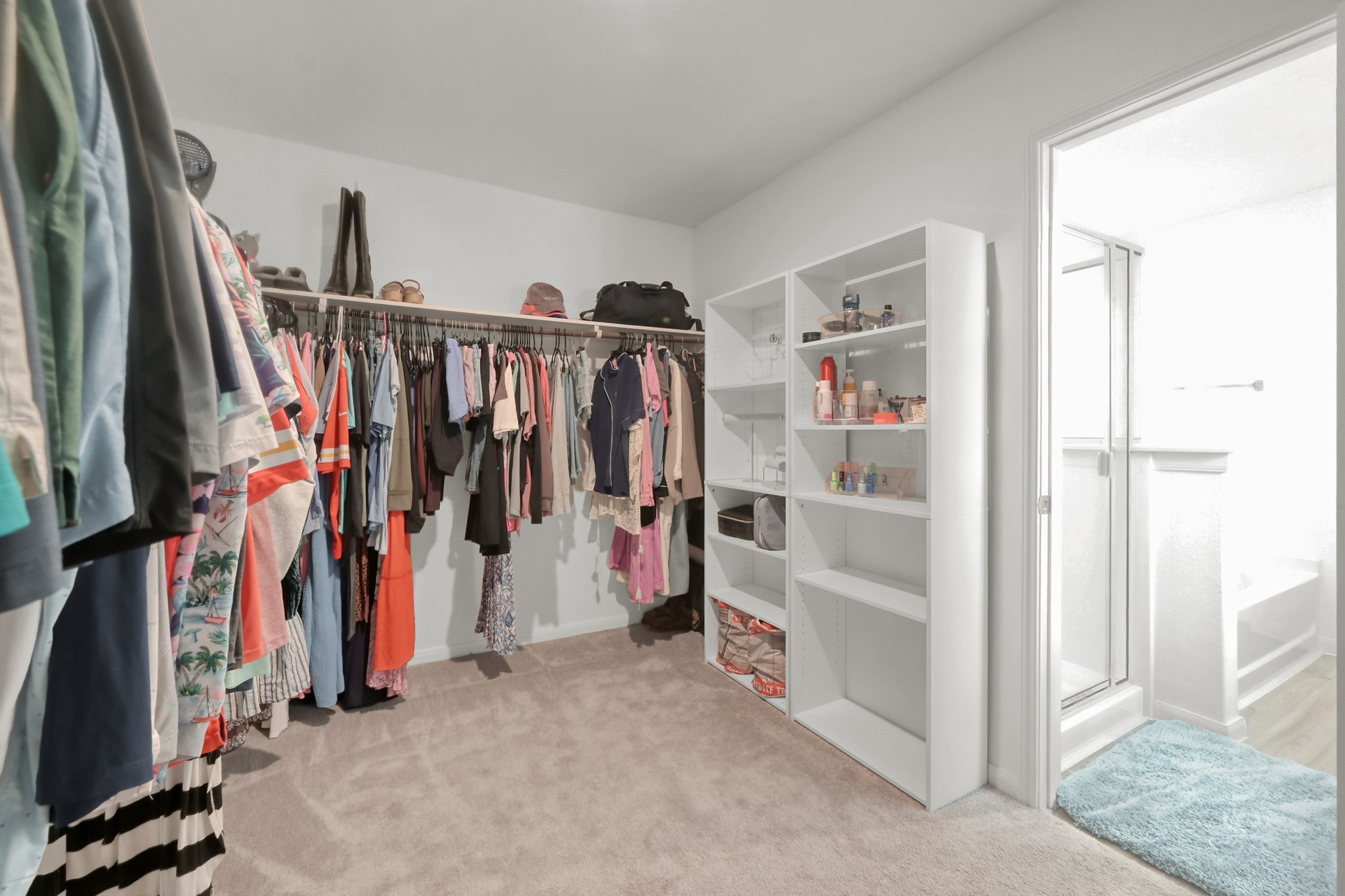 23562 Glenbuck Street Spring, TX 77373 - Photo 21 of 30 a view of walk in closet with clothes